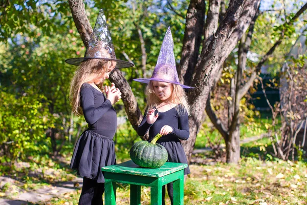 Adorable little girls in witch costume on Halloween have fun — Stock Photo, Image