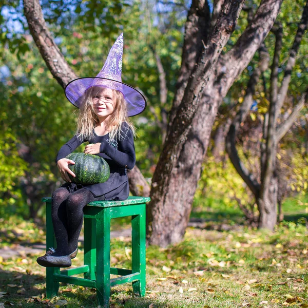 Adorable little girl in witch costume on Halloween — Stock Photo, Image