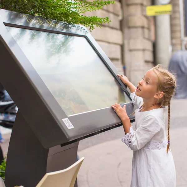 Little cute girl looking the map of Milan Royalty Free Stock Images