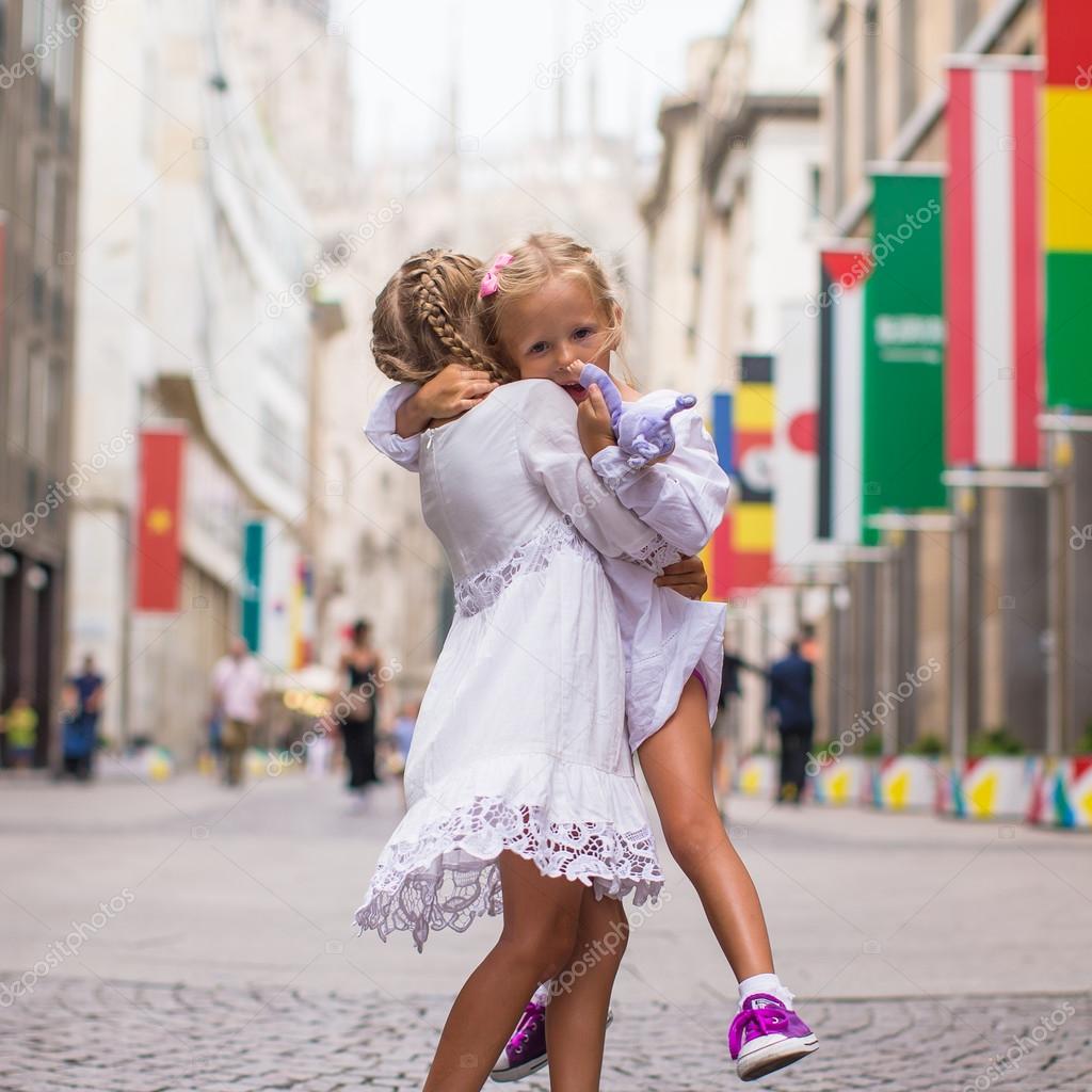 Little beautiful girls walking in Milan