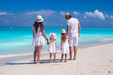 Tropikal plaj sırasında genç güzel ailesinin arkadan görünüm