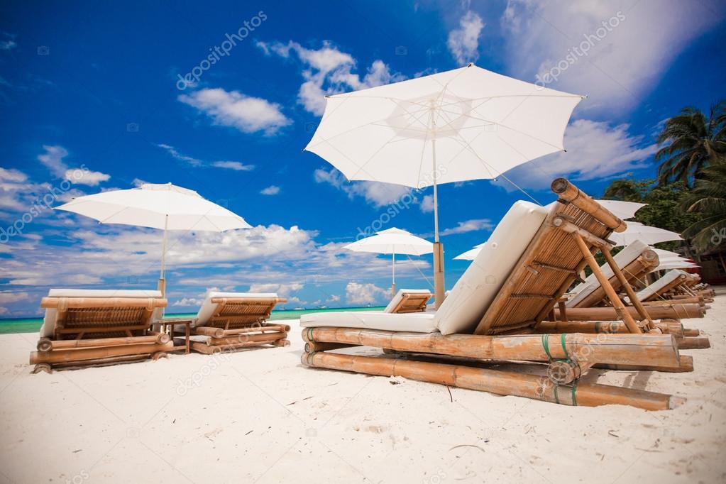 Beach wooden chairs for vacations on tropical beach