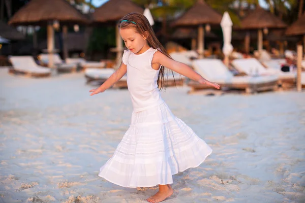 Entzückende kleine Mädchen haben Spaß am Sonnenuntergang Strand — Stockfoto