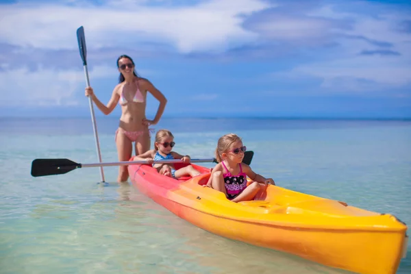 Young mother and two her little daughters kayaking at tropical warm sea — Stock Photo, Image