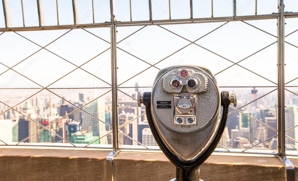 Public telescope pointed on Manhattan buildings