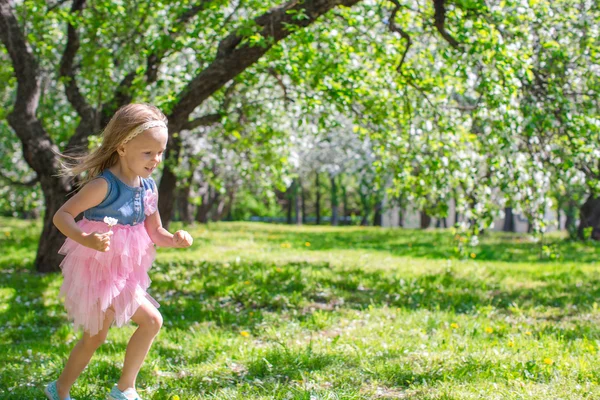 Adorable little girl in blossoming apple garden — Stock Photo, Image