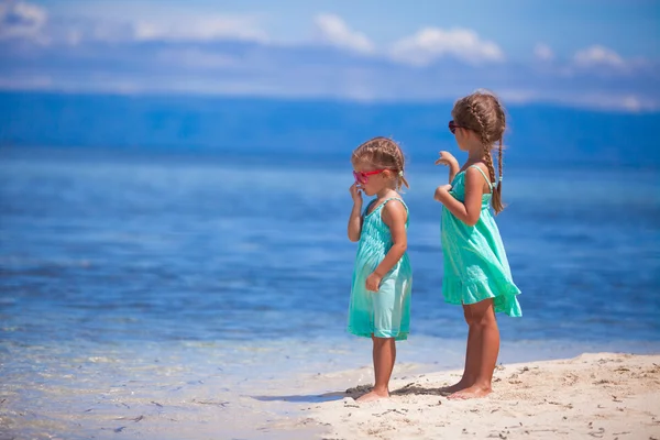 Little adorable girls on white beach look at the sea — Stock Photo, Image