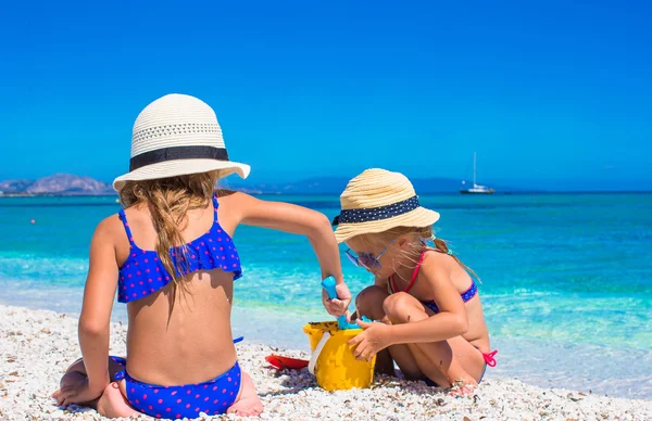 Little adorable girls playing with beach toys during vacation — Stock Photo, Image