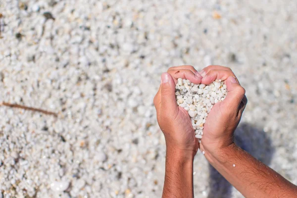 Hands in the form of heart with pebbles inside — Stock Photo, Image