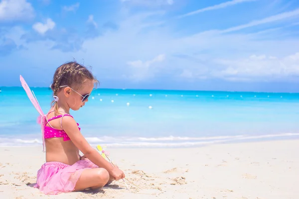 Adorable little girl with wings like butterfly on beach vacation — Stock Photo, Image