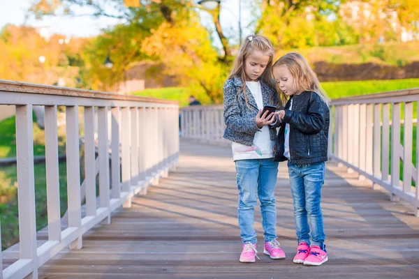 Adorable little girls at warm autumn day outdoors — Stock Photo, Image