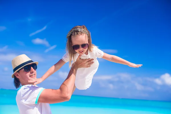 Papá joven y su adorable hijita se divierten en las vacaciones en la playa tropical — Foto de Stock