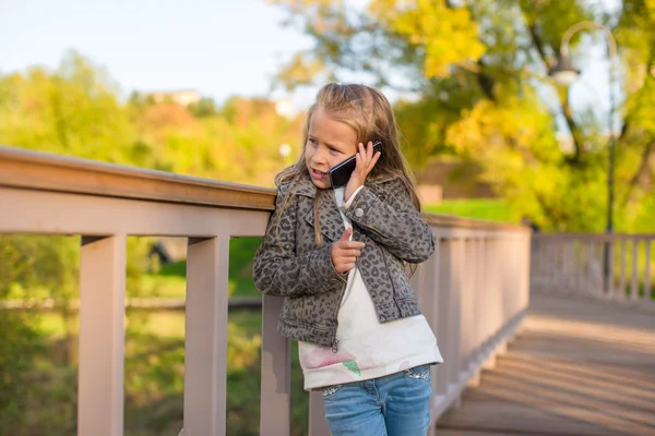 Adorable little girl at warm autumn day outdoors — Stock Photo, Image