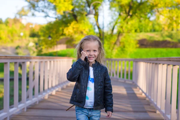 Adorable little girl at warm autumn day outdoors — Stock Photo, Image