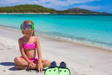 Palet ve gözlük snorkling beyaz plaj üzerinde küçük kızla