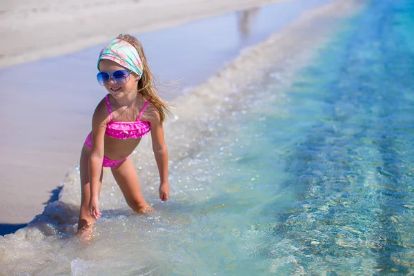 Aranyos kislány szórakozni sekély vízben tropical beach — Stock Fotó