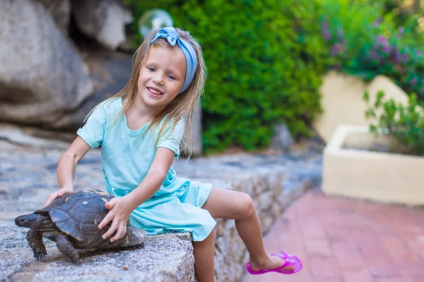 Little adorble happy girl with small turtle outdoors — Stock Photo, Image