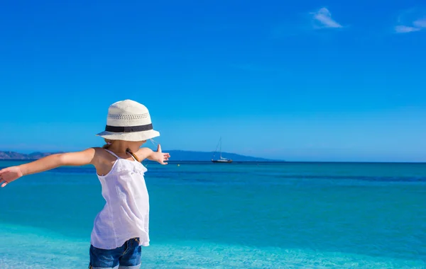 Malá holčička baví na tropické pláži s bílým pískem a tyrkysově oceán vody — Stock fotografie