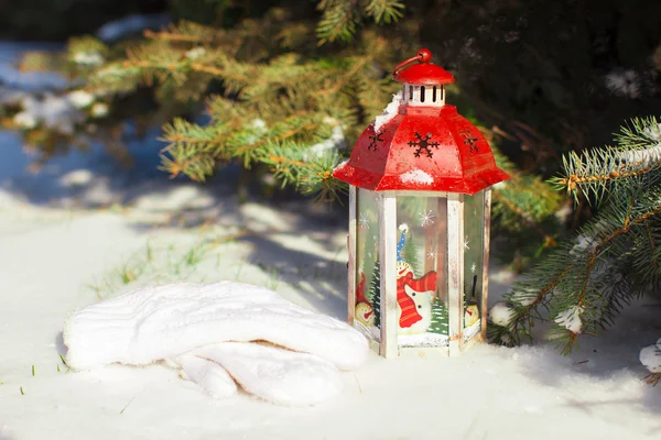 Beautiful red fairytale lantern on white snow in forest — Stock Photo, Image