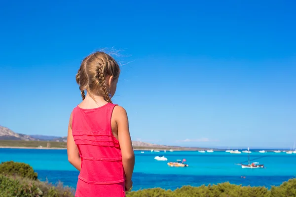 Little adorable girl enjoying beautiful view of turquoise sea — Stock Photo, Image