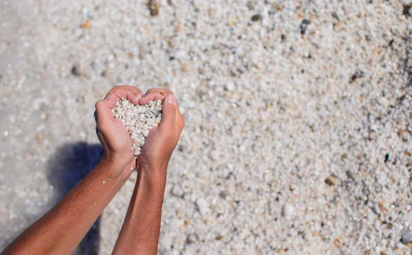 Hands in the form of heart with pebbles inside — Stock Photo, Image