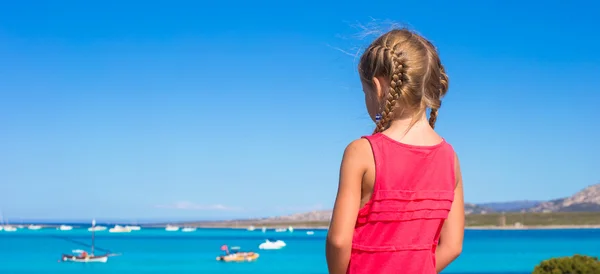 Little adorable girl enjoying beautiful view of turquoise sea — Stock Photo, Image