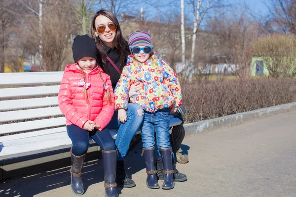 Little girls and young mother have fun outdoors — Stock Photo, Image