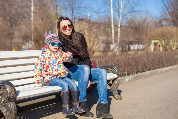 Little cute girl with her mother walking on sunny day outdoors — Stock Photo, Image