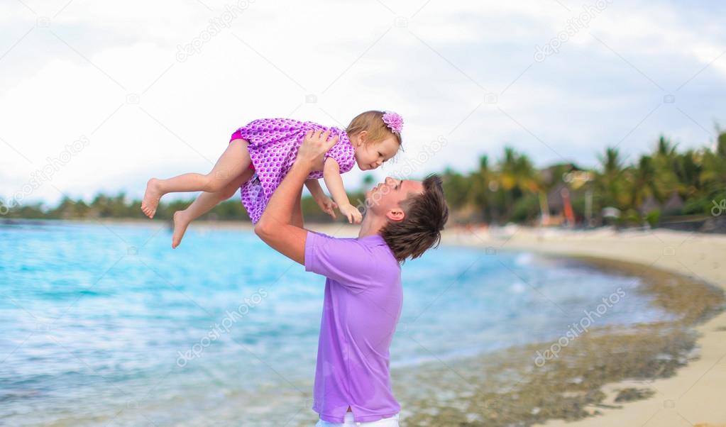 Happy father and his adorable little daughter at tropical beach