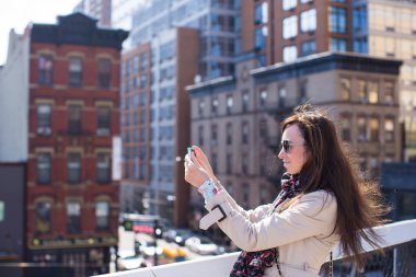 Young woman photographed New York City at High Line Park clipart