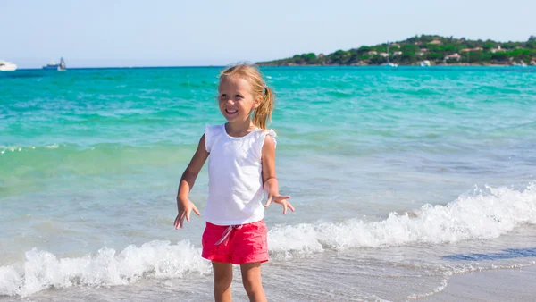 Entzückendes kleines Mädchen, das während des tropischen Strandurlaubs Spaß hat — Stockfoto