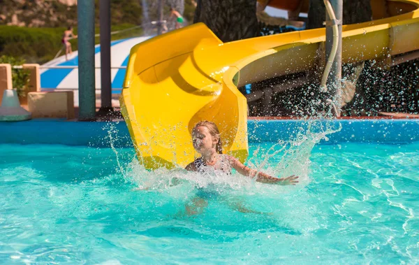 Su kaydırağı aquapark yaz tatili sırasında üzerinde küçük kız — Stok fotoğraf