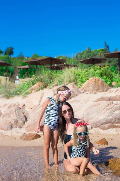 Little adorable girls and happy mother during beach vacation — Stock Photo, Image