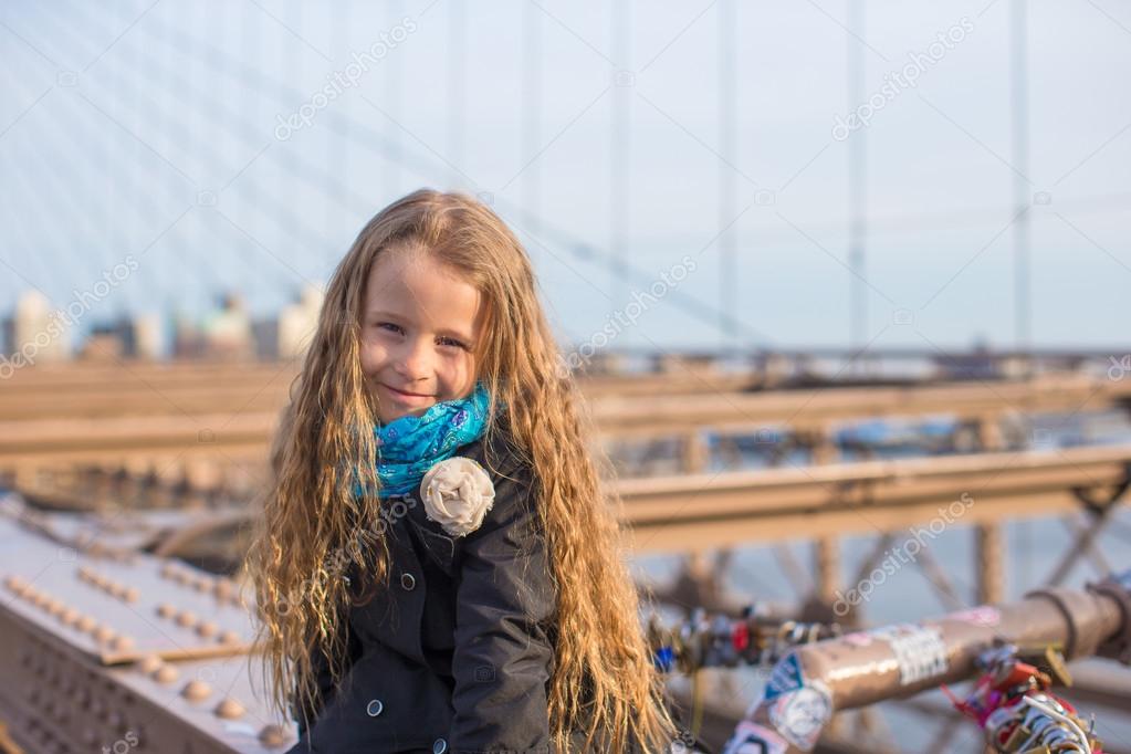 Adorable little girl sitting at Brooklyn Bridge