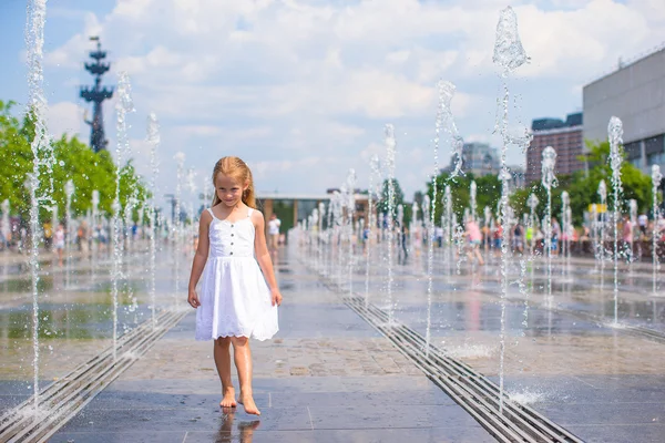 Nettes Mädchen hat Spaß im Brunnen im Freien bei heißem Tag — Stockfoto