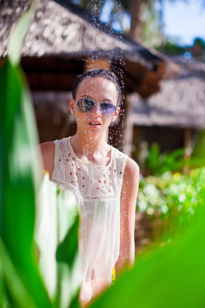 Young girl in tropical shower during beach vacaion — Stock Photo, Image