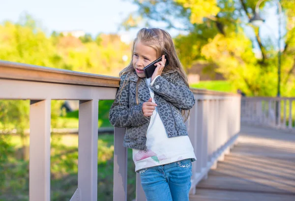 Adorable little girl at warm autumn day outdoors — Stock Photo, Image