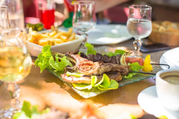 Fresh dinner of salad and meat in outdoor cafe