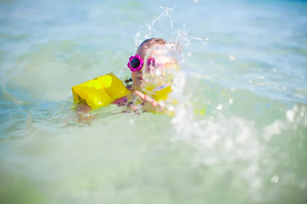 Little happy girl at swimsuit having fun in clear sea — Stock Photo, Image