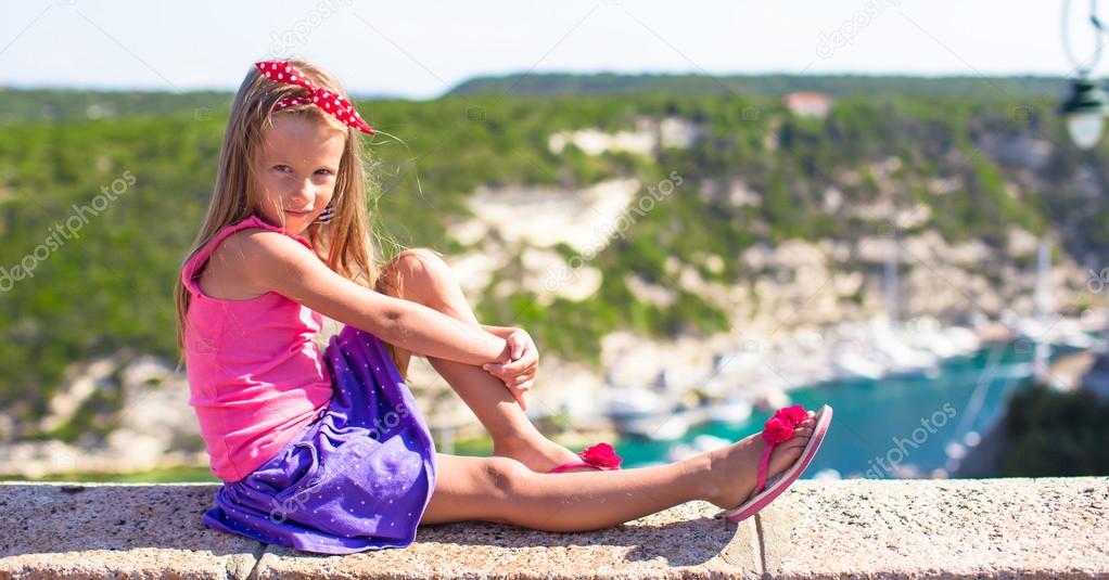 Little adorable girl outdoors with beautiful view in Bonifacio city, Corsica