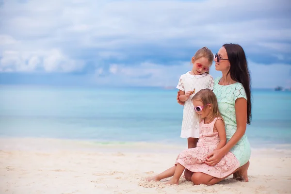 Happy mother and two her kids at exotic beach on sunny day — Stock Photo, Image