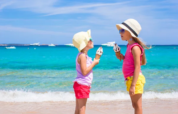 Urocze dziewczynki, jedzenie lodów na tropikalnej plaży — Zdjęcie stockowe