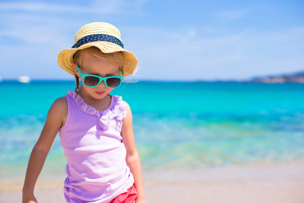 Adorable little girl have fun at tropical beach during vacation