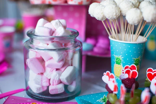 Marshmallow, sweet colored meringues, popcorn, custard cakes and cake pops on table — Stock Photo, Image