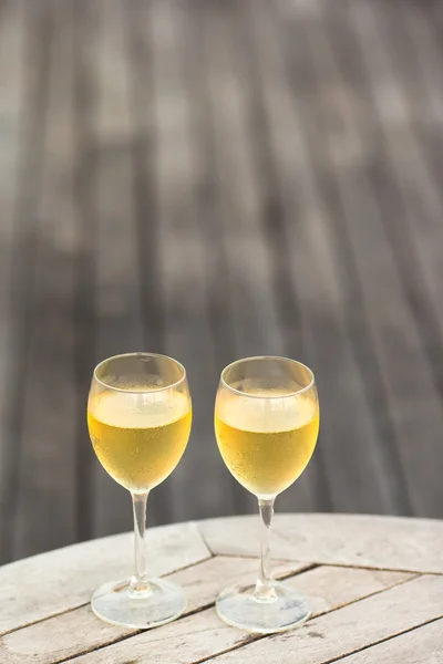Due bicchieri di buon vino bianco al tramonto sul tavolo di legno — Foto Stock