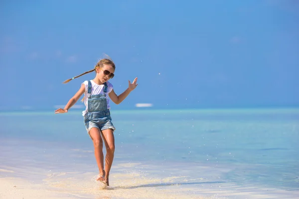 Roztomilý šťastný usměvavá holčička se bavit na pláži dovolenou — Stock fotografie