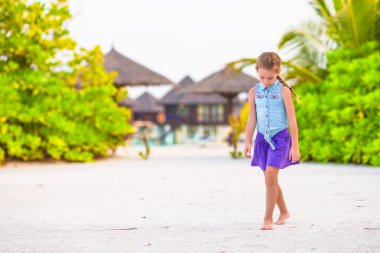 Yaz tatili boyunca sahilde sevimli küçük bir kız.