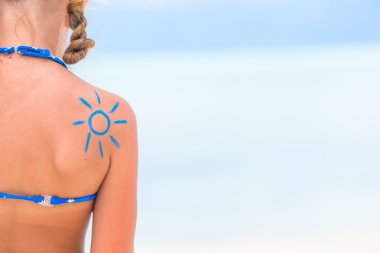 Close up sun painted by sun cream on kid shoulder clipart