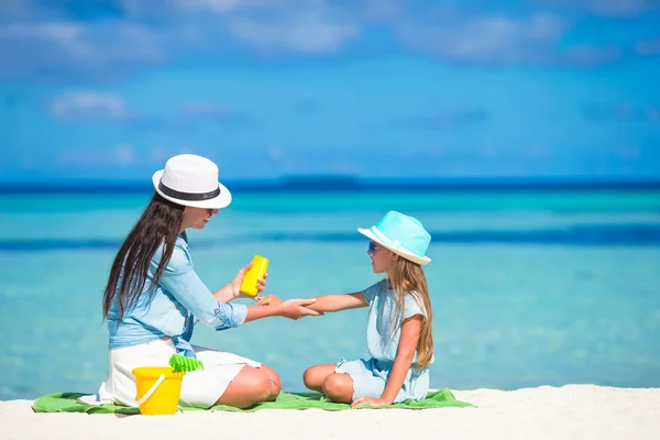 Young mother applying sunscreen on her kid — Stock Photo, Image