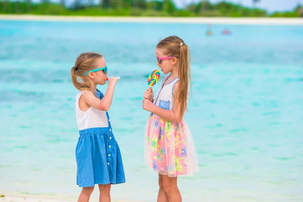 Adorables petites filles avec sucette sur la plage tropicale — Photo